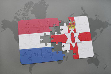 puzzle with the national flag of netherlands and northern ireland on a world map background.