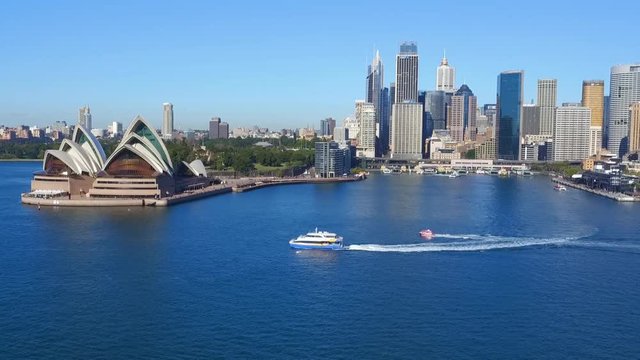 Aerial footage of Ferry at Sydney Opera House in Sydney Harbour, featuring Sydney CBD, Sydney Sky Line, City, Sydney Opera House, Sydney Harbour bridge, Sydney Ferries (ferry), Circular Quay,  