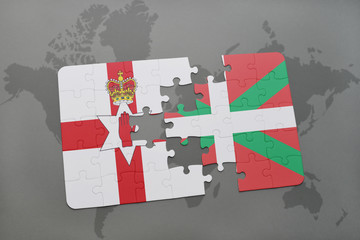 puzzle with the national flag of northern ireland and basque country on a world map background.