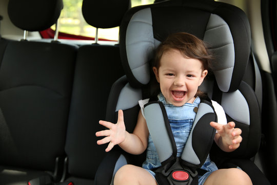 Boy sitting in a car in safety chair