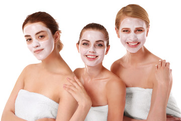 Three beautiful women wrapped in towels isolated on white