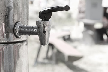 Close up Water taps on cooler tank in black and white tone