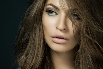 Woman with beauty long brown hair - posing at studio