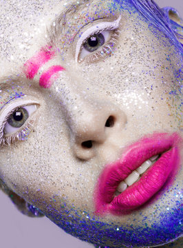 Holiday Make-up.Beautiful Woman's Face with pink lips and blue p