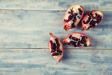 juicy pomegranate on white wooden table