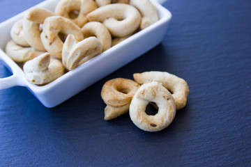 Bagels on a small ceramic tray on a slate floor