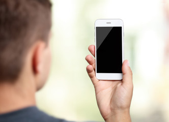 Young man with gadget on blurred background