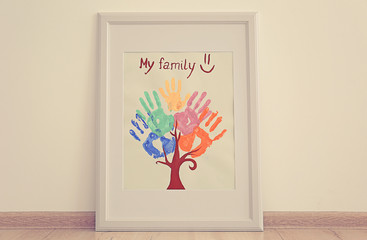 Family hand prints in frame on floor