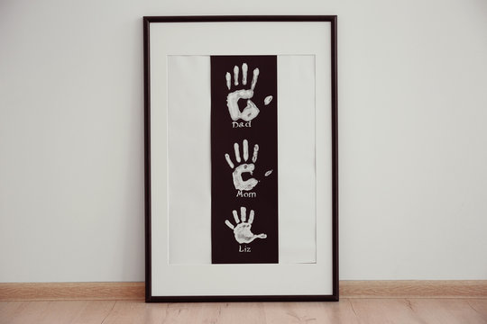 Family hand prints in frame on floor