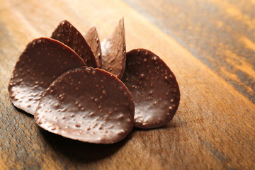 Chocolate crisps on wooden background