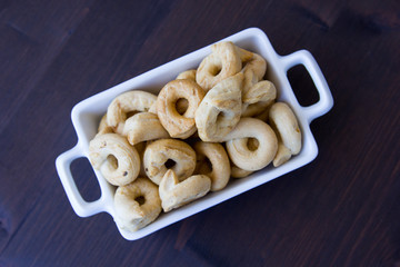 Bagels on a small ceramic tray on a wooden table seen from above