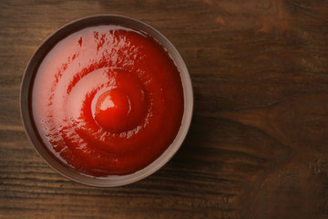 Tomato sauce on wooden background