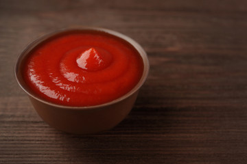 Tomato sauce on wooden background