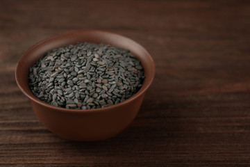 Sesame seeds on wooden background