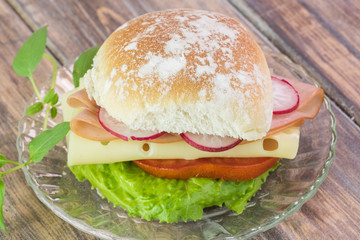 Ham cheese sandwich with vegetables.