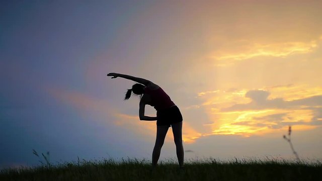 young girl goes in for sports on a hill sunset fitness