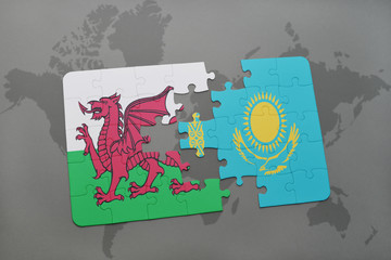 puzzle with the national flag of wales and kazakhstan on a world map background.
