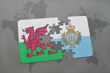 puzzle with the national flag of wales and san marino on a world map background.