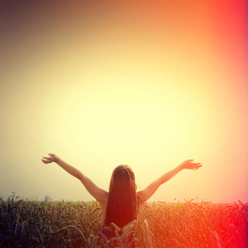 Girl lift her hands to the sky and feel freedom.