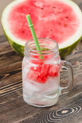 Watermelon Drink in Glass with Slices on Wooden Background