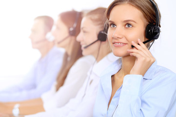 Young beautiful business woman in headset. Call center operator.