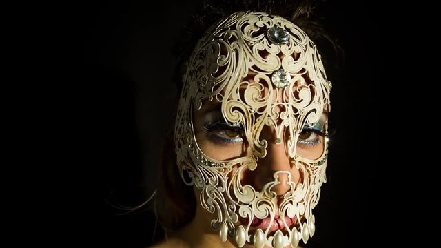 woman wearing an delicate venetian skull mask