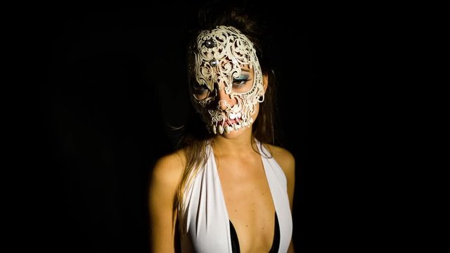 woman wearing an delicate venetian skull mask