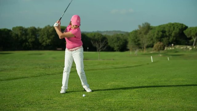 beautiful senior female golf player golf course