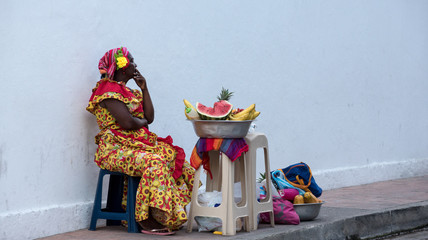 Woman sells fruits in the streets of Cartagena Colombia - obrazy, fototapety, plakaty