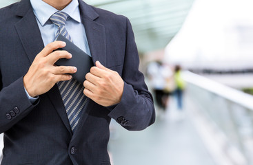 isolated business man hold the smartphone on bridge background
