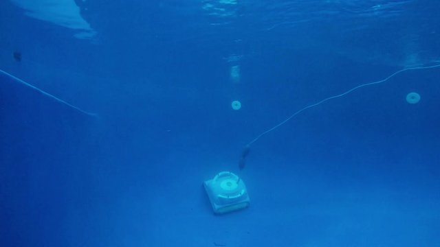 Underwater shot of automatic swimming pool cleaner robot.