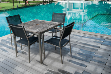 Table and chairs with swimming pool.