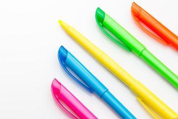 Multi color highlighters on white background