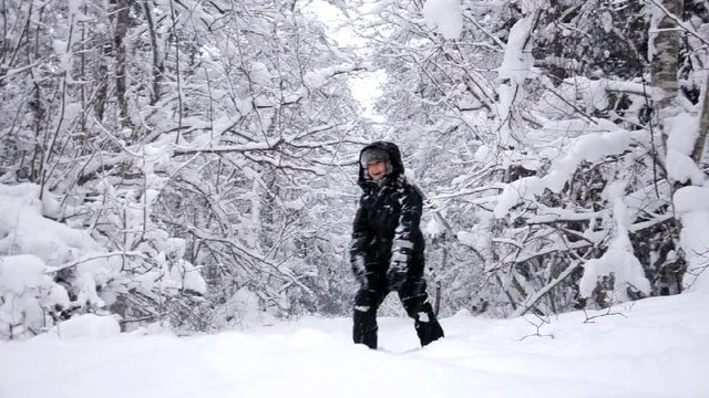 Child playing in winter forest