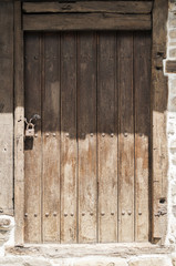 Old weathered wooden countryside brown door closeup