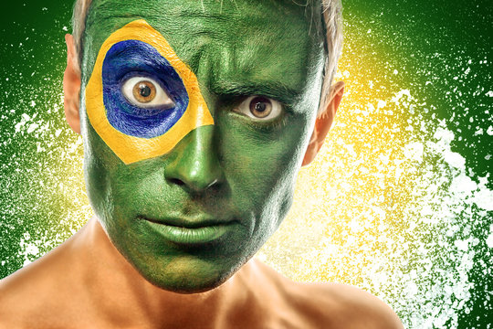 man with brazil flag painted on face