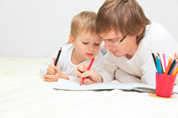 father and son drawing or writing, education