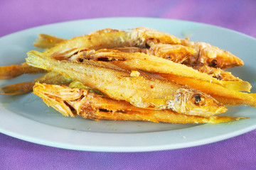 Deep fried fish with fresh turmeric