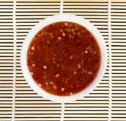 bowl of chili sauce on wood background