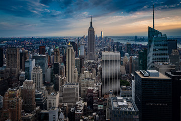 Aerial view of midtown Manhattan at night, the heart of a financial empire that dominates the business world, with every building vividly colored in shades of blue and green in NYC, state of New York