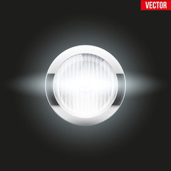 Round car headlight is on.