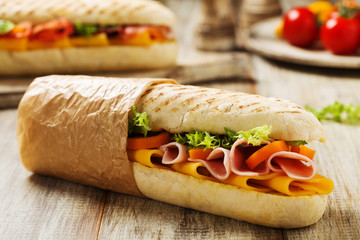 Traditional Italian sandwich with ham and cheese served warm.