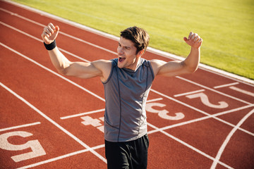 Sportsman celebrating his victory at a stadium