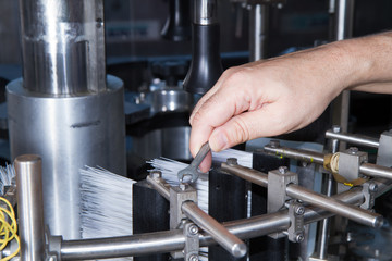 skilled worker while fixing a bottling plant during maintenance work