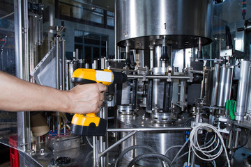 skilled worker while fixing a bottling plant during maintenance work