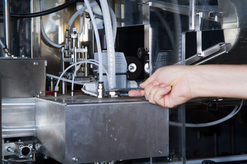 skilled worker while fixing a bottling plant during maintenance work