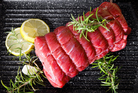 Roast Of Beef With Rosemary On Plate Pot On Black