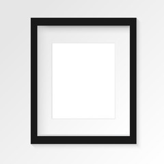 Black vertical photo frame on gray wall with realistic shadows. Vector illustration. EPS10.