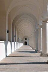 Classical white colonnade  with sharp shadows in perspective.
