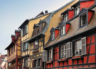 Fototapeta na wymiar Pitched roof with skylight of old half-timbered houses of different colors. Colmar, Alsace, France.